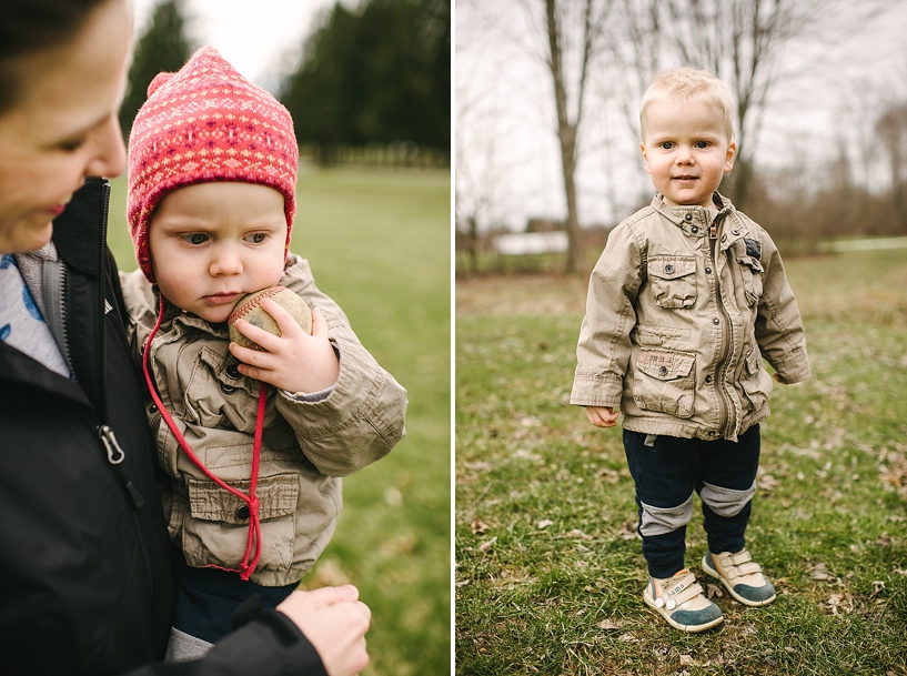 mother holding son wearing red winter hat carrying baseball