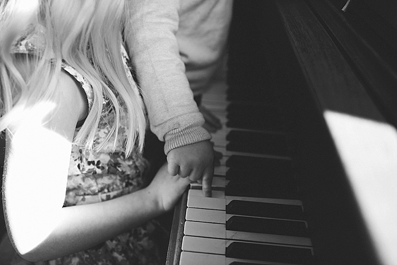 children playing piano in their home