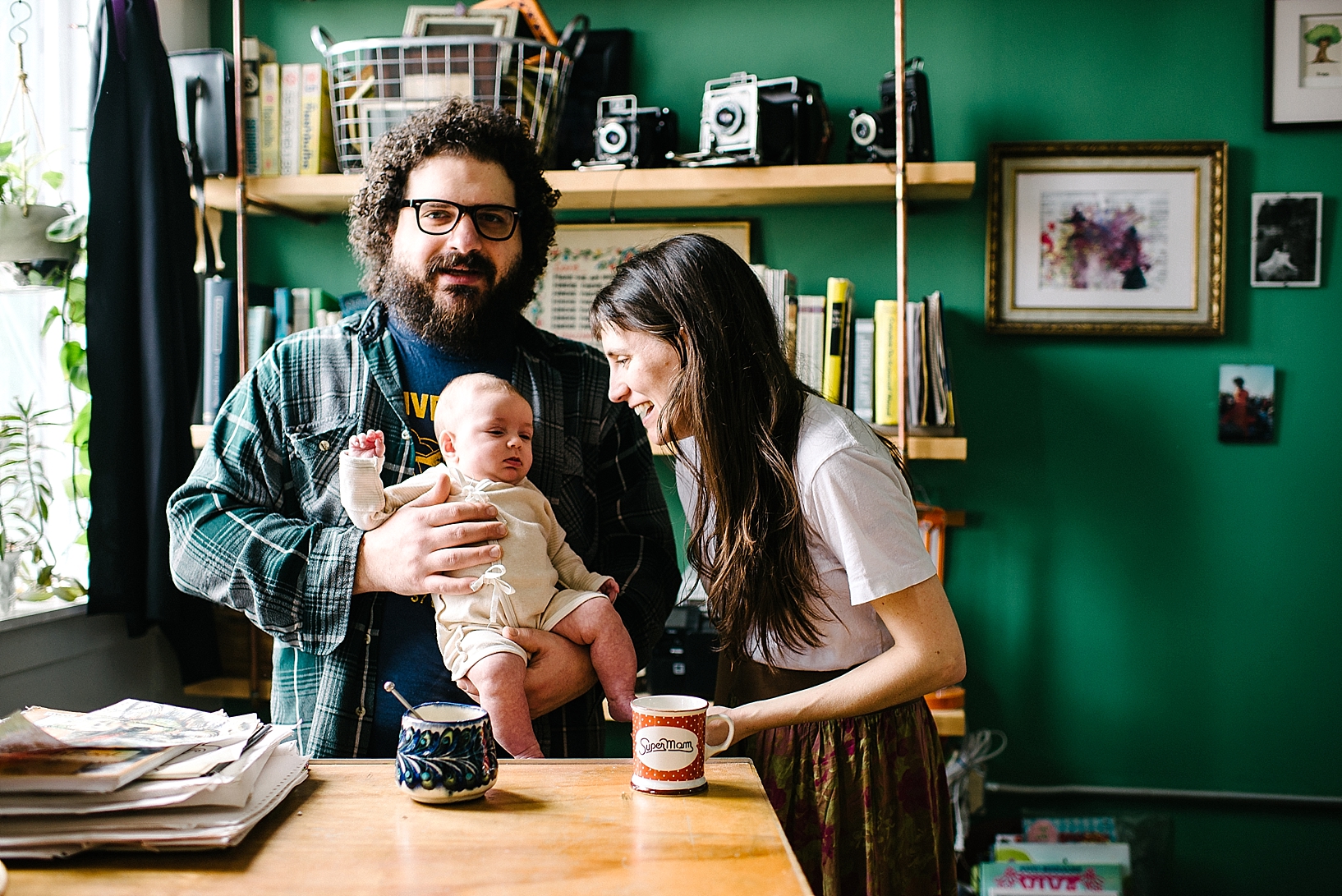 bohemian parents holding infant drinking tea