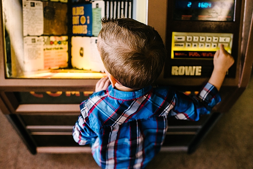 young boy standing at juke box