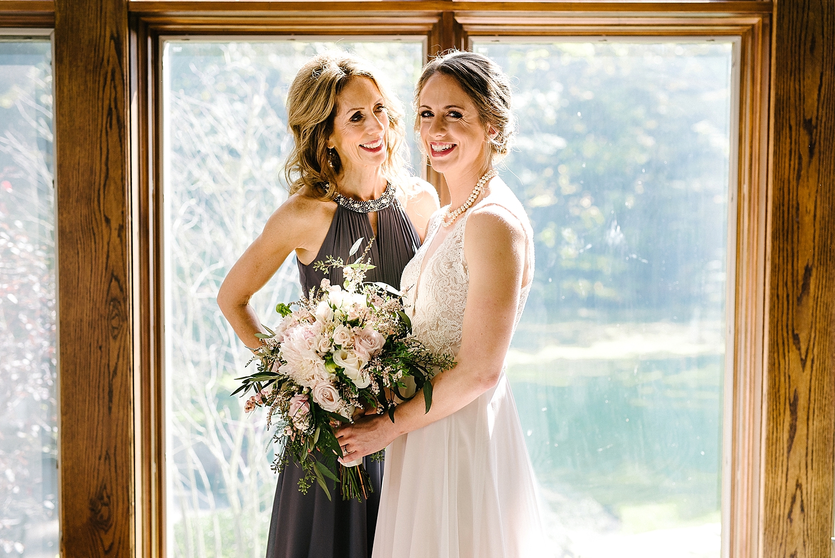 bride and her mother standing in living room