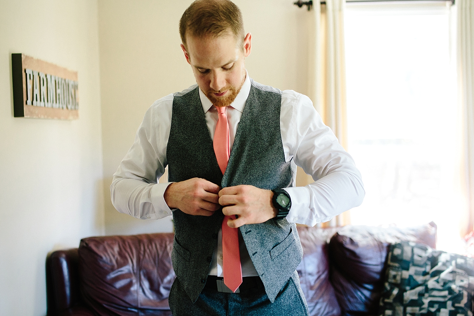 groom buttoning vest