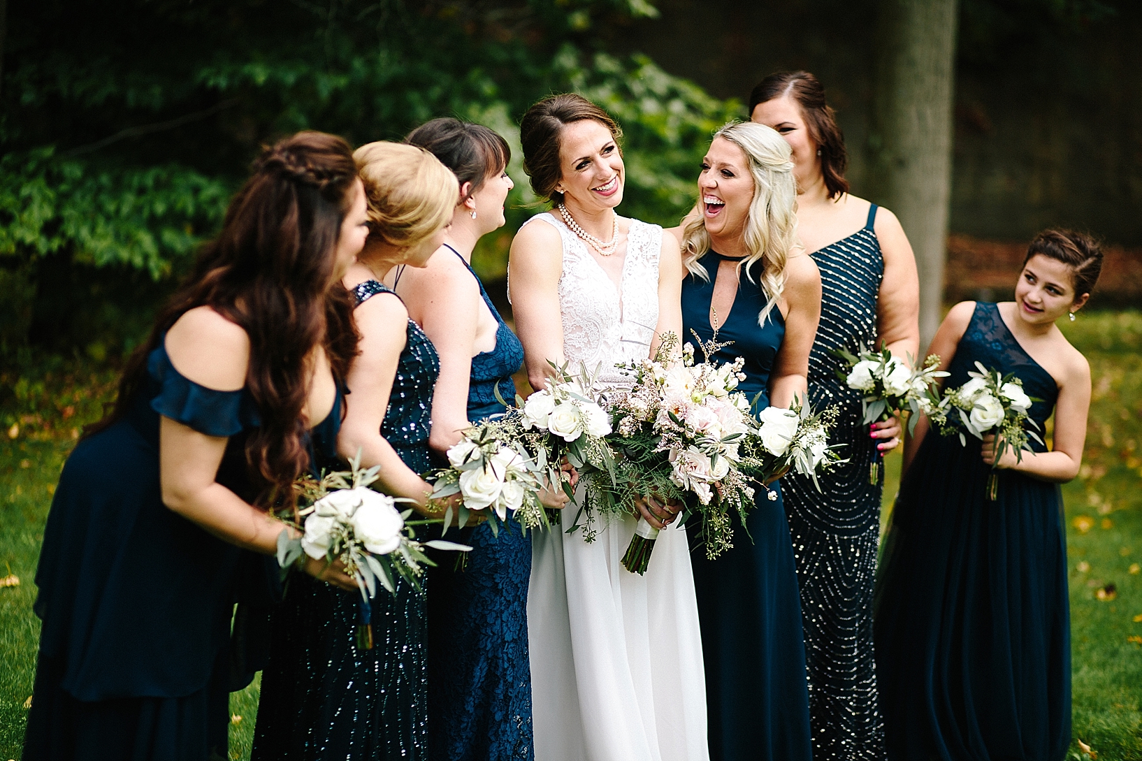 bride and her bridesmaids in navy blue dresses