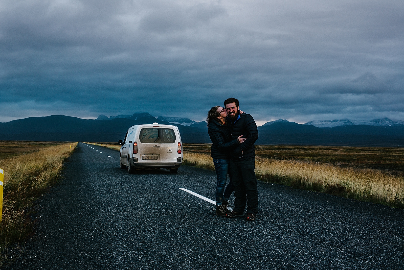 couple standing on Ring Road with camper van in Iceland