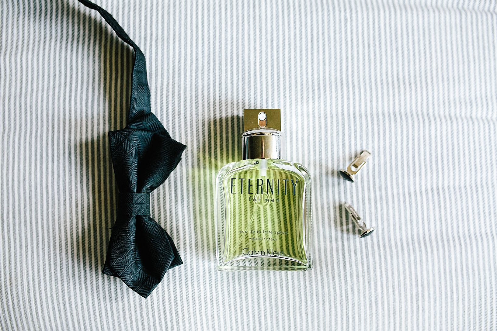 groom's cologne and bow tie