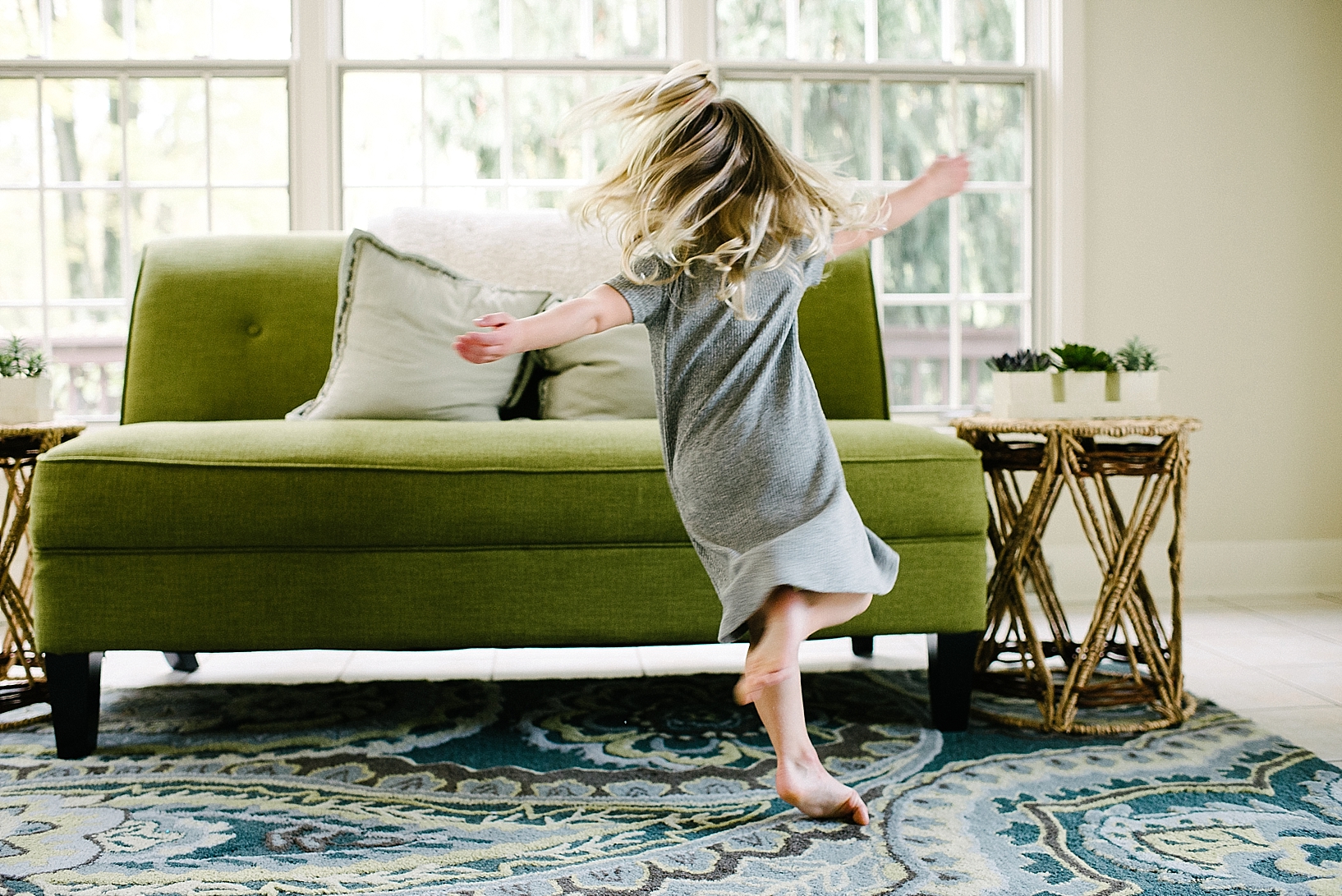 little girl dancing and twirling in living room