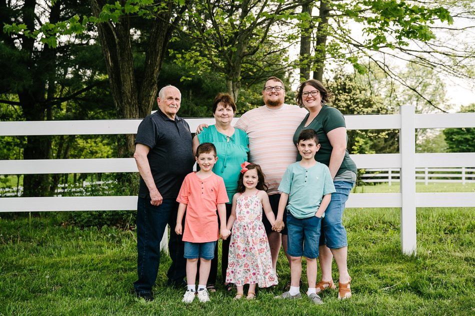 Grandma and Grandpa pose with family of 5 during generational family session.