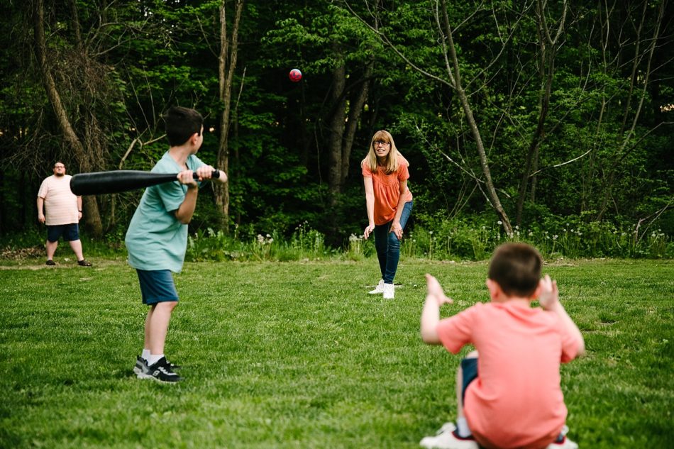 Woman throws baseball to two boys in backyard of home in Ohio
