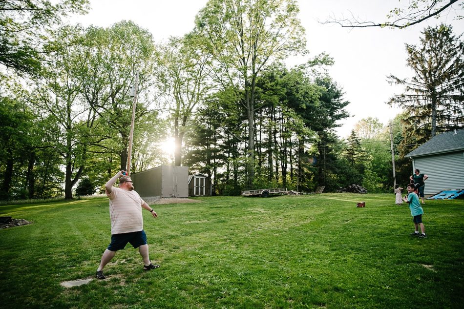 Dad throws baseball to son in backyard of home in Ohio