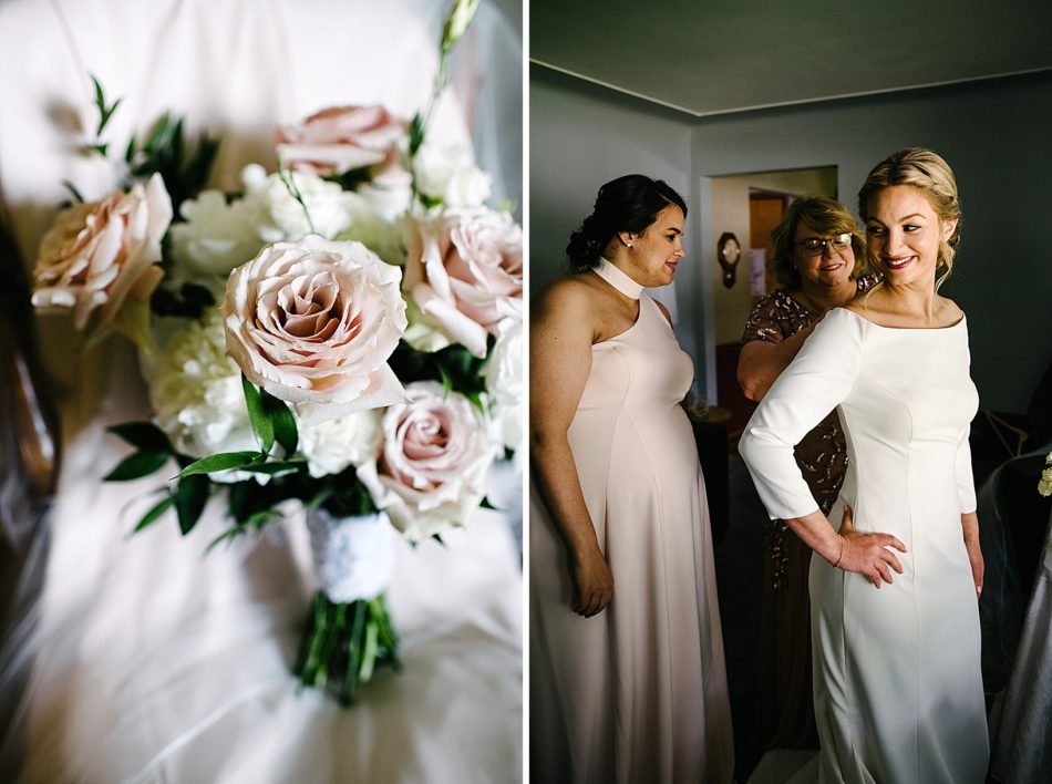 Mother of bride zips up bride's gown while bridesmaid helps