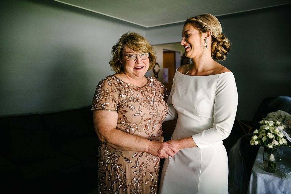 Bride and mother of the bride smile together