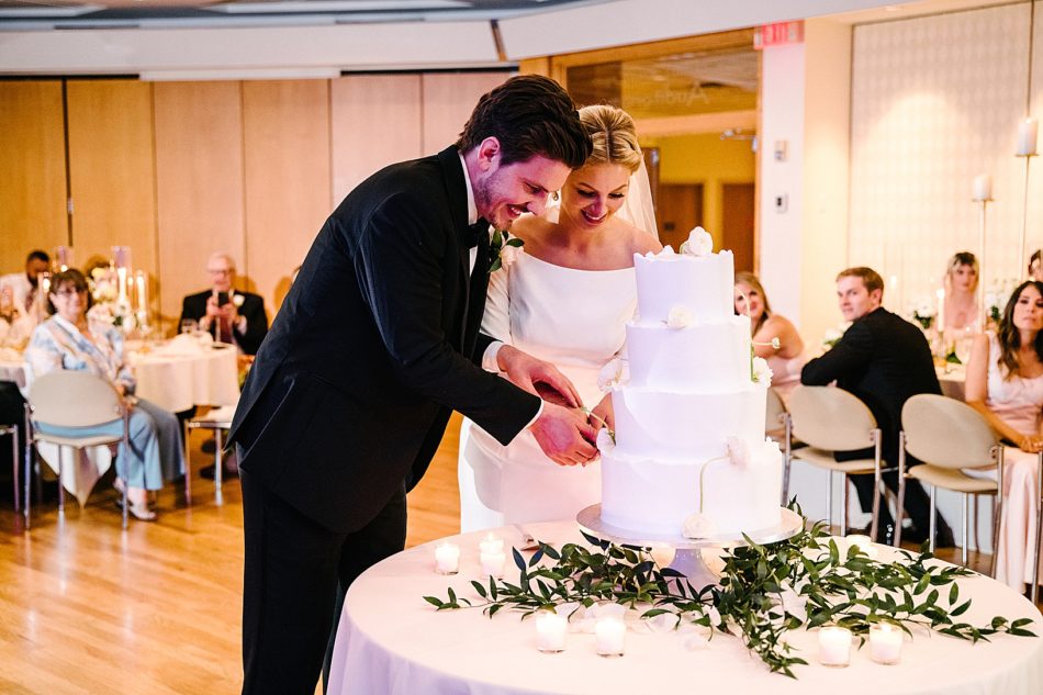 Bride and Groom cut cake during Fellows Riverside Gardens wedding
