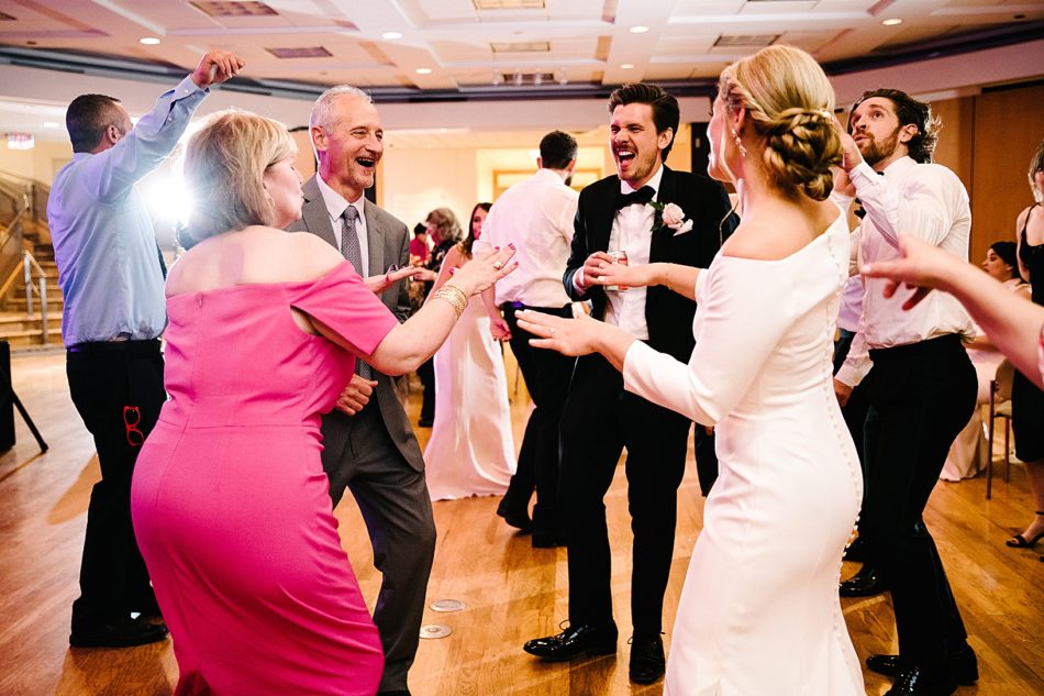 Groom, Bride, and older couple dance in a circle
