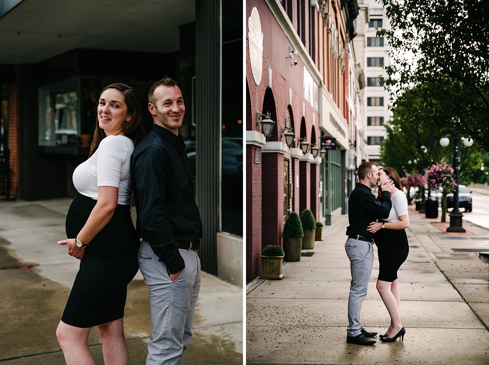 Pregnant wife and husband are standing back to back smiling while wife holds her belly.