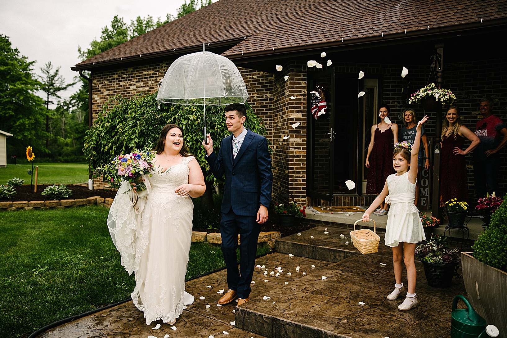 Groom holds clear umbrella as they leave the DiLucia's Banquet Hall