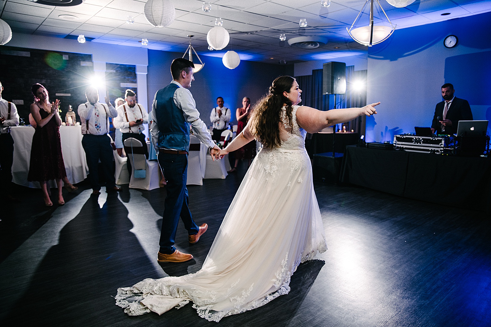 Groom and Bride exit the dance floor after their first dance