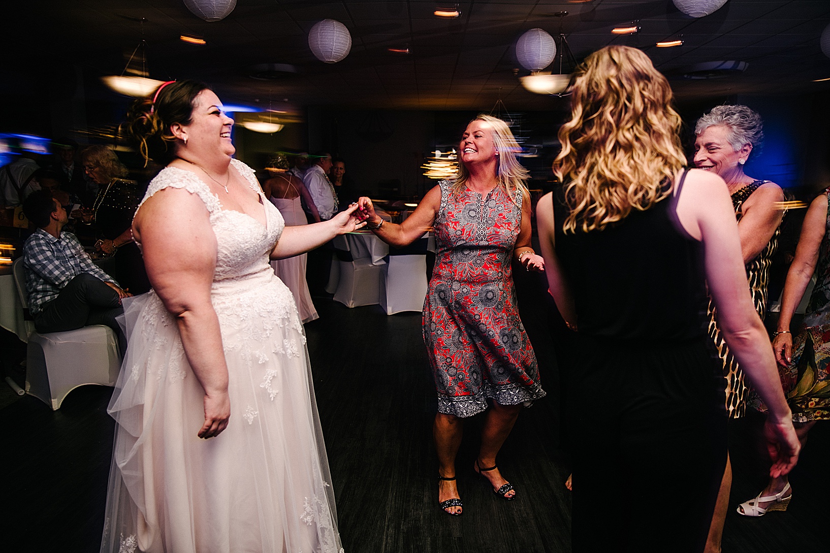 Bride dances with woman on dance floor at DiLucia's Banquet Hall post wedding celebration