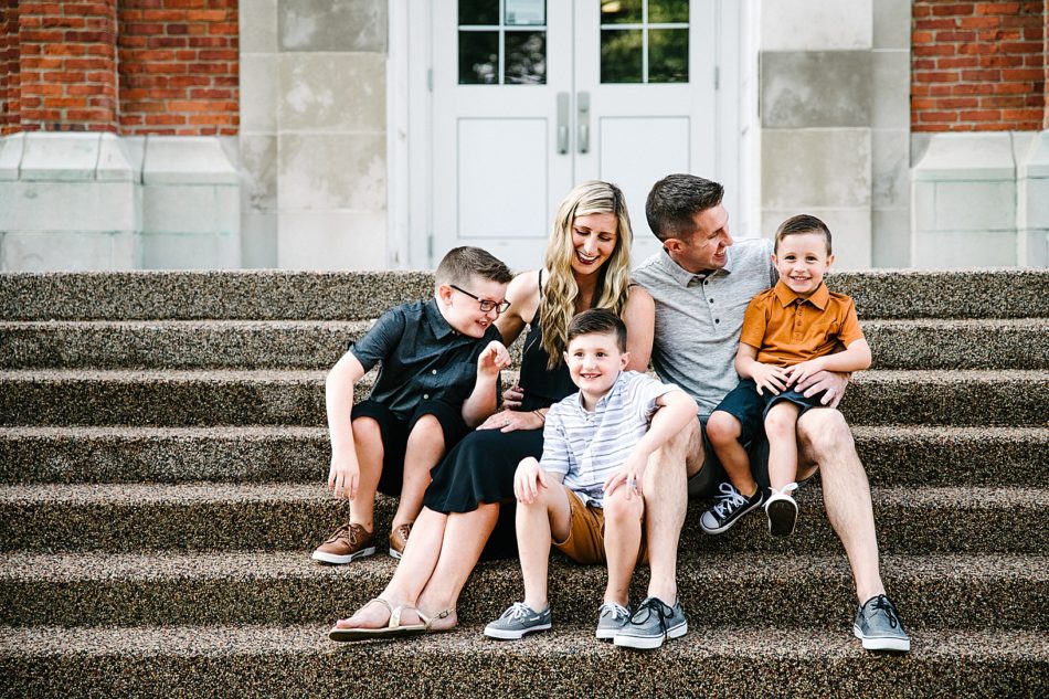 Mom, dad, and three boys all pose together on steps at Mount Union.