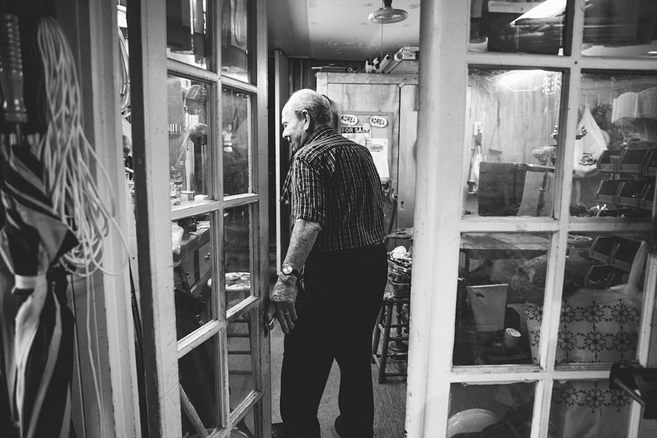 Grandfather smiles and looks around as he enters his tool shed at his home in East Liverpool. .