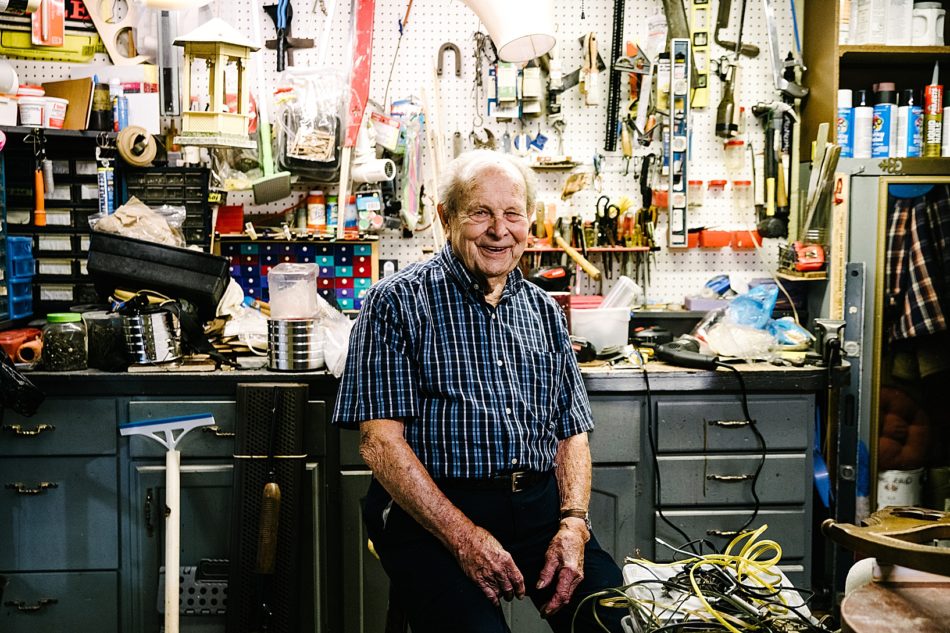 Grandfather smiles and poses in his tool shed with a wall of tools behind him at his home in East Liverpool. .