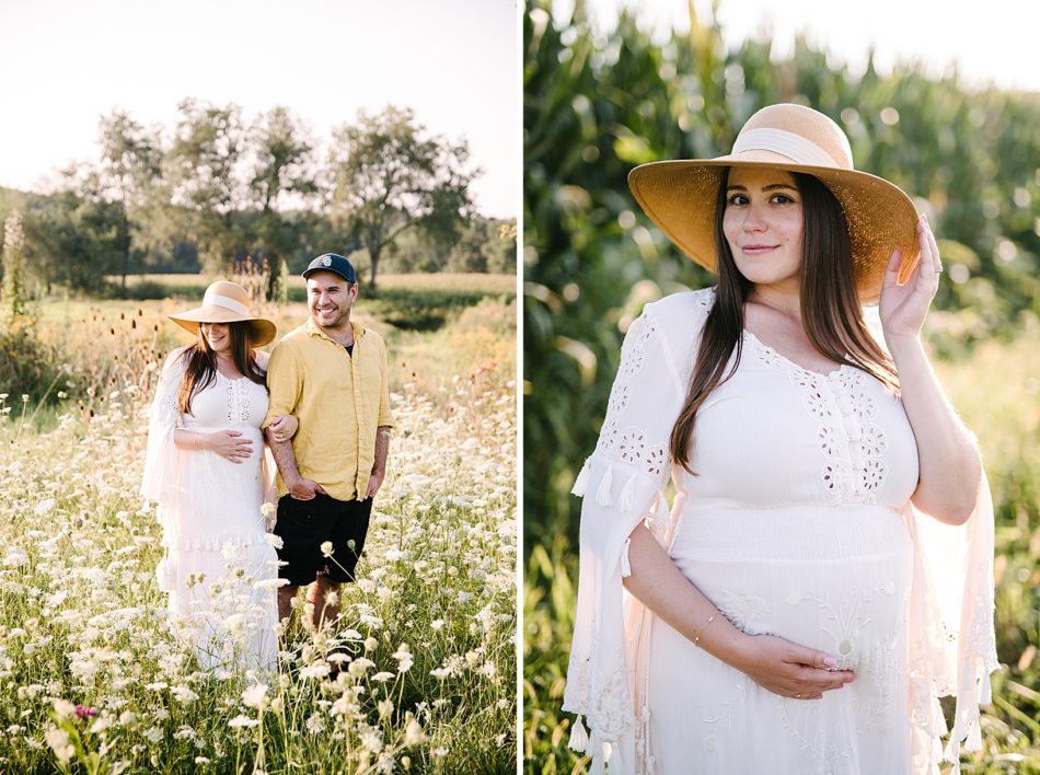Man and pregnant wife walk through their flower farm wildflower field while holding arms and smiling