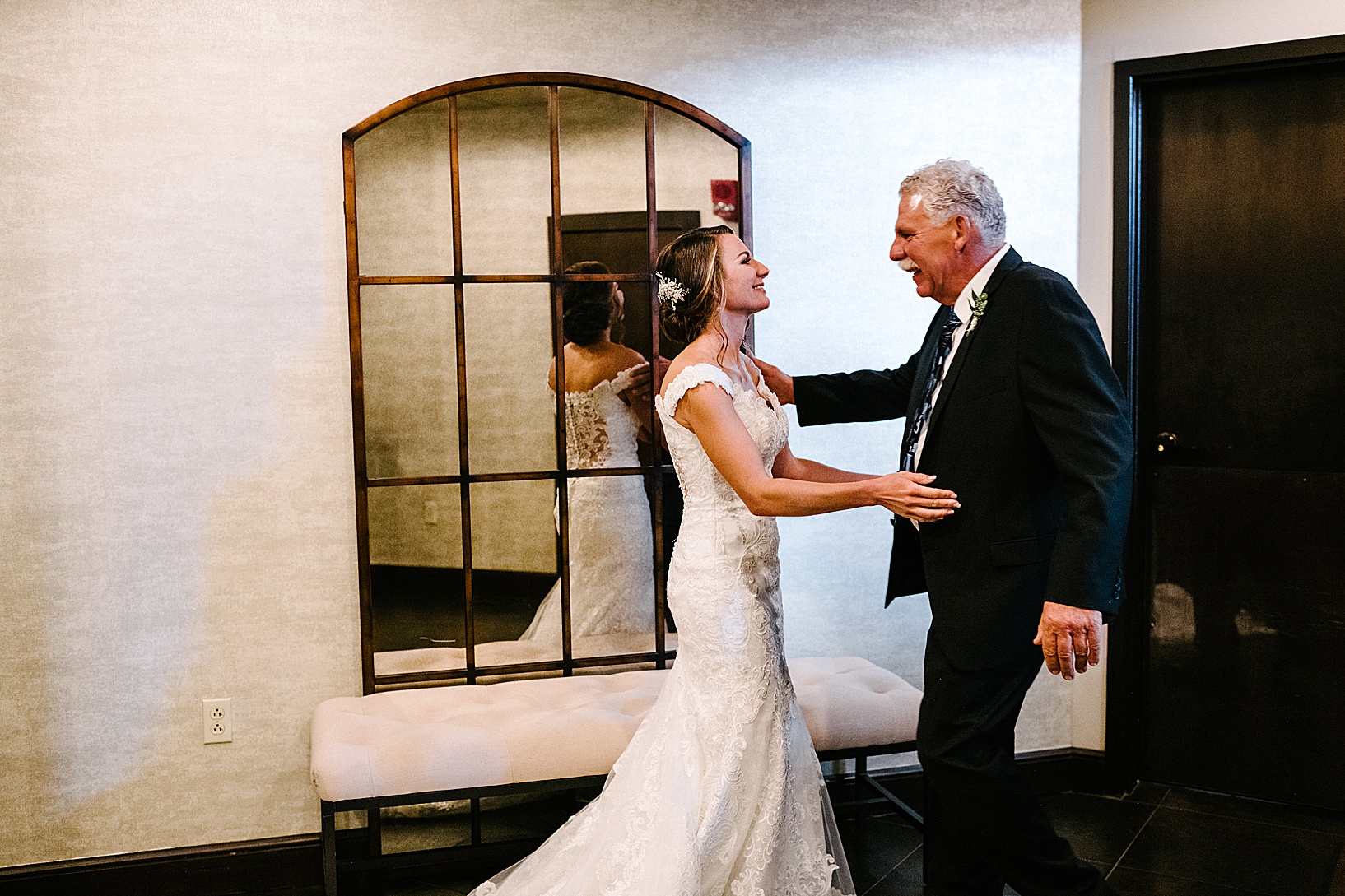 Father of the bride and bride going to hug as he sees her for the first time