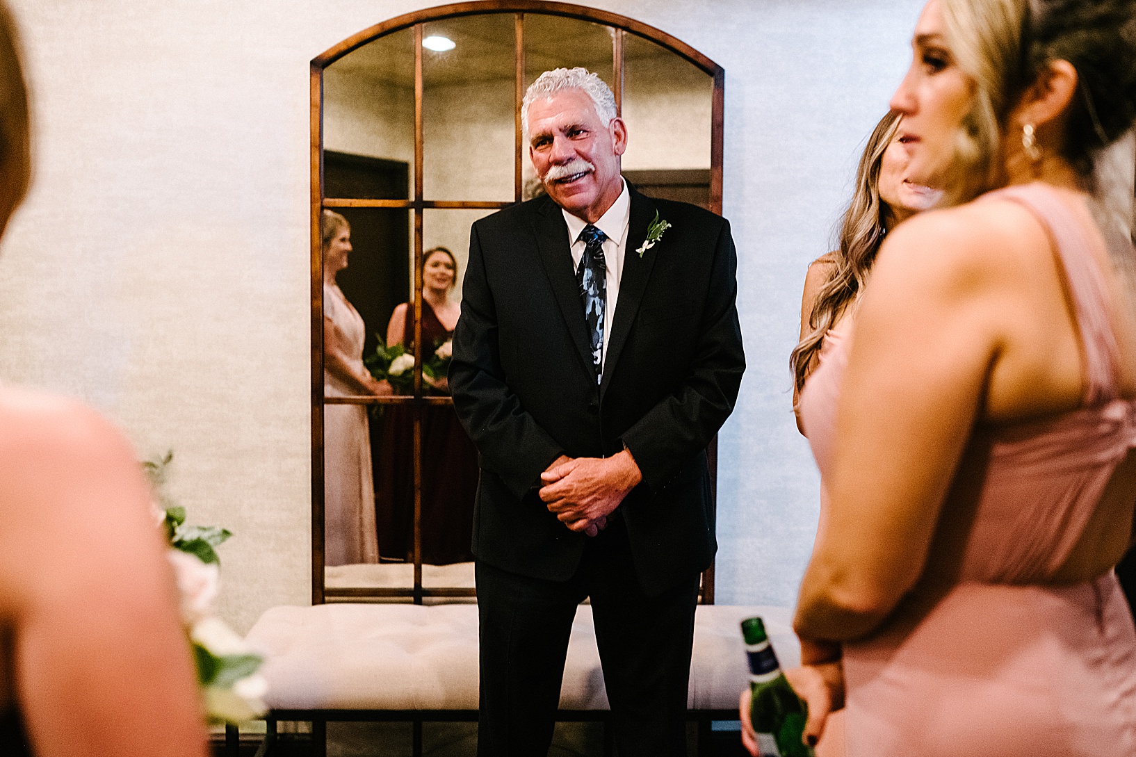 Father of the bride smiling with love as he sees the bride for the first time.