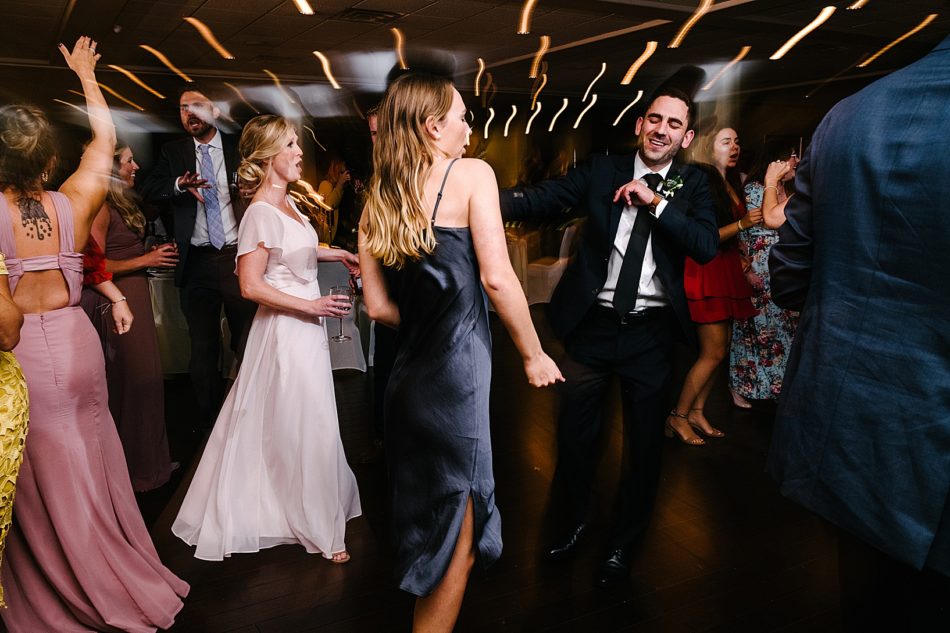 Wedding guests dance on the dancefloor of the Lake Club.