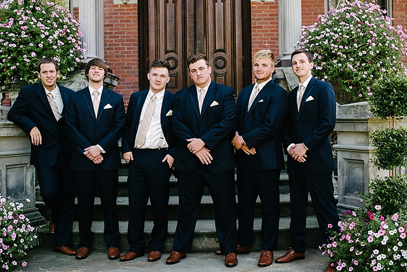 groomsmen in navy suits and brown shoes