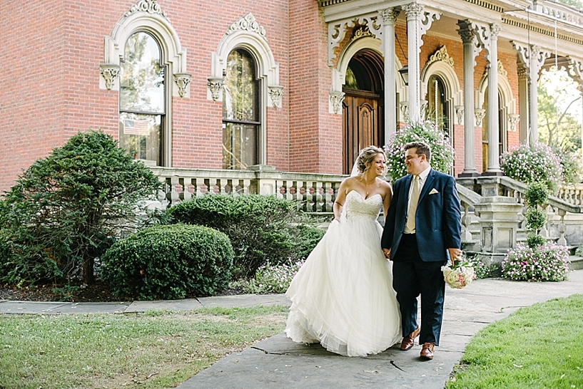 bride and groom walking in front of City Hall Warren
