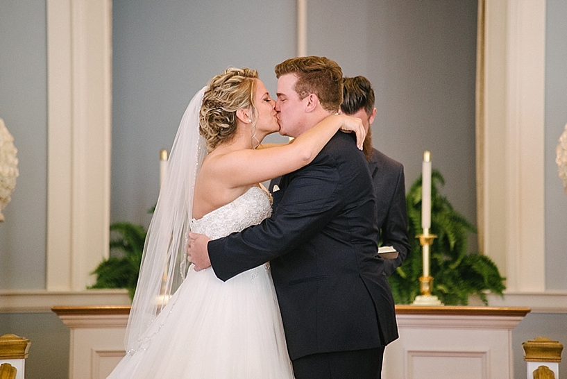 bride and groom share first kiss