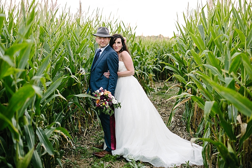 stylish bride and groom in corn maze