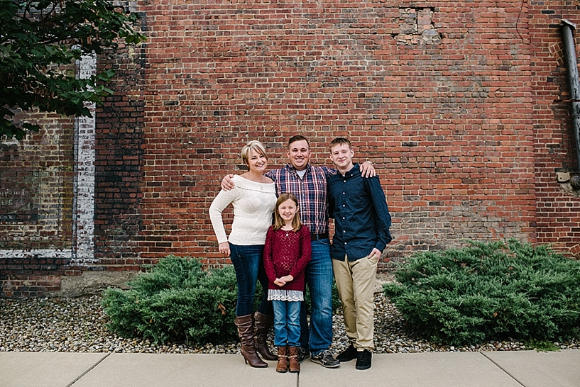 Family standing in front of brick wall downtown Yougnstown OH
