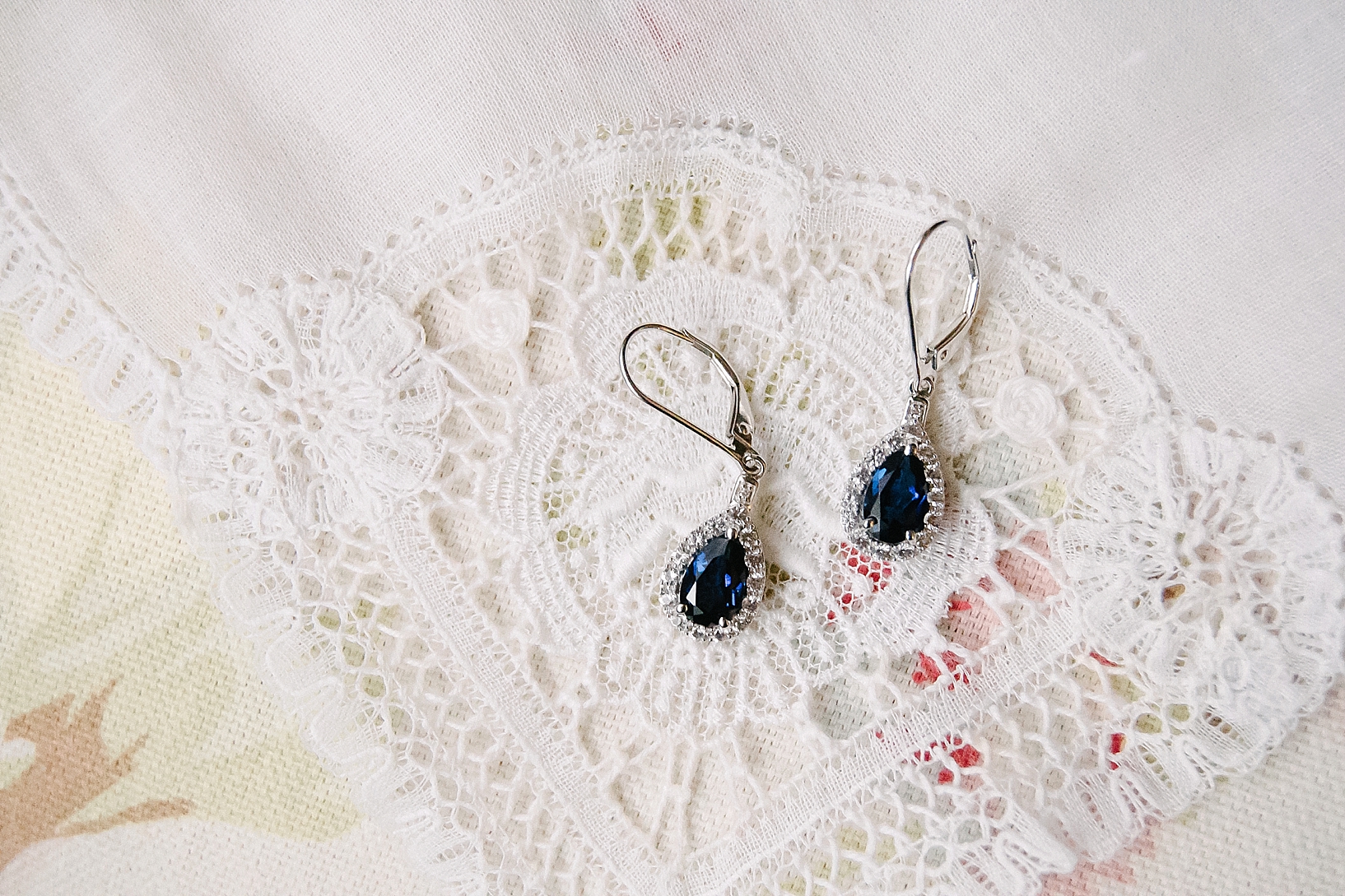 blue sapphire earrings on lace handkerchief
