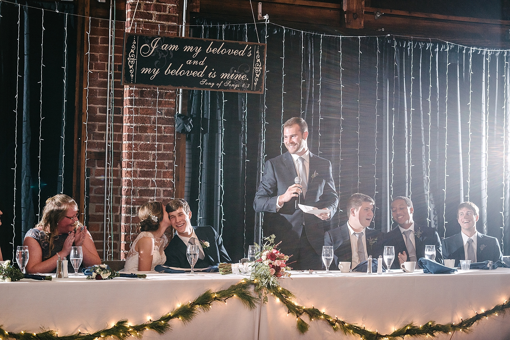 best man giving toast at wedding reception