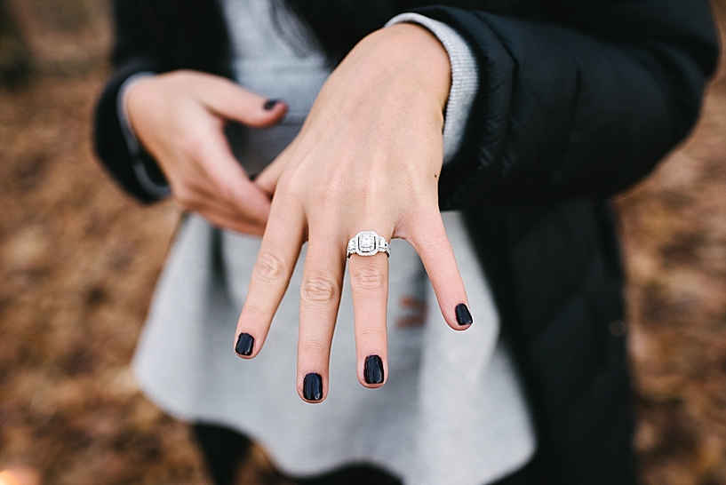 woman showing off new diamond engagement ring on her hand