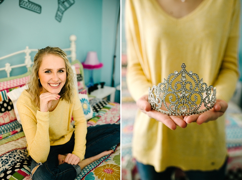 teenage girl with blonde hair holding homecoming queen crown sitting in her bedroom