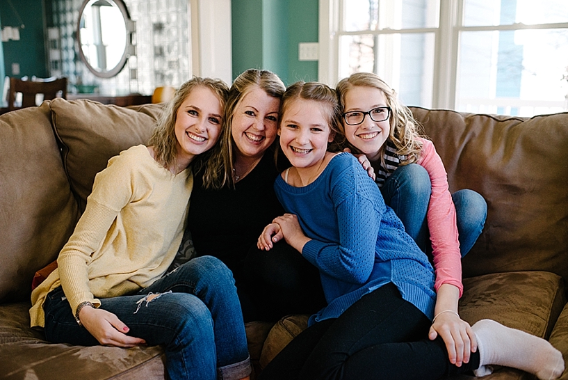 mom and daughters sitting on couch