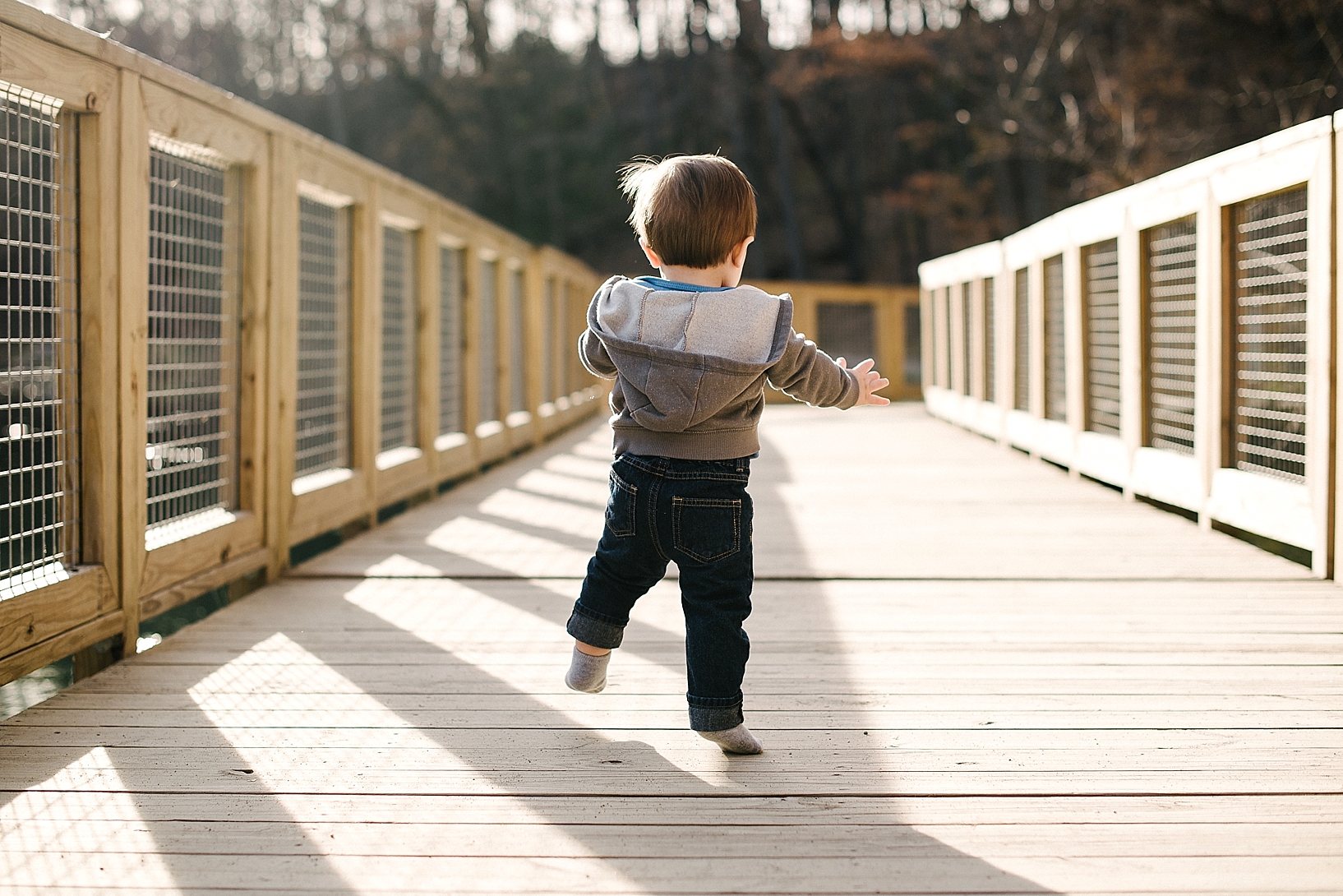 little boy walking on bridge at Lily Pond