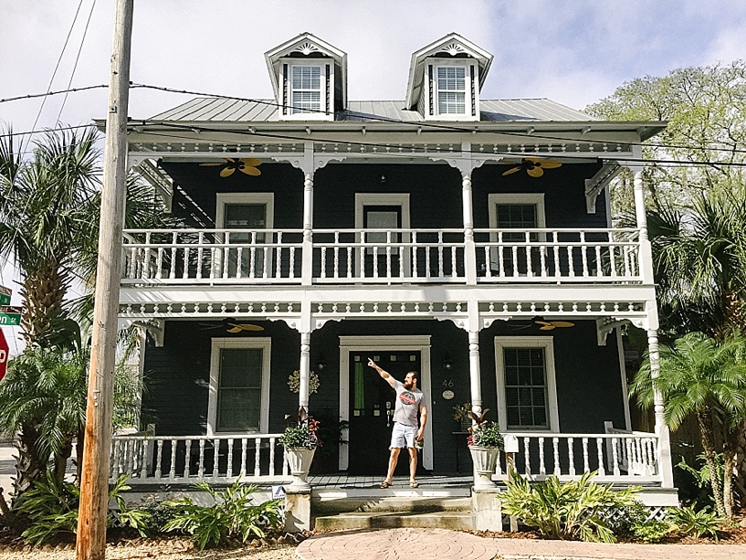 man standing on front porch of two story beach house in St Augustine FL