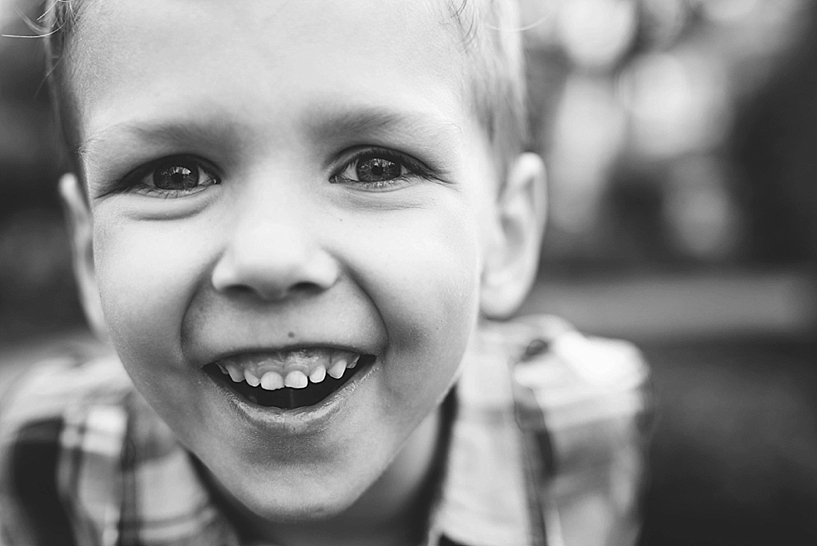 young boy laughing into the camera