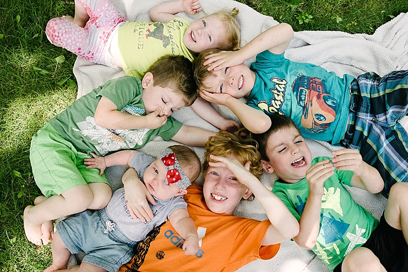 bunch of kids laying on blanket