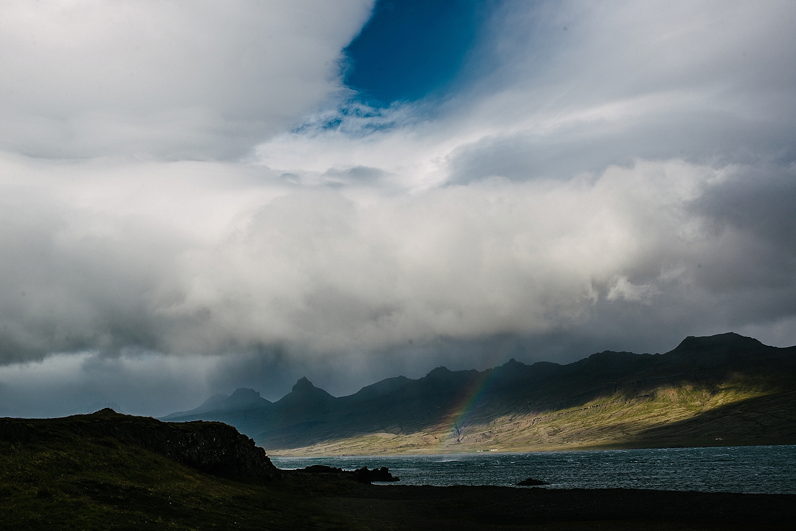 rainbow through the clouds in Iceland