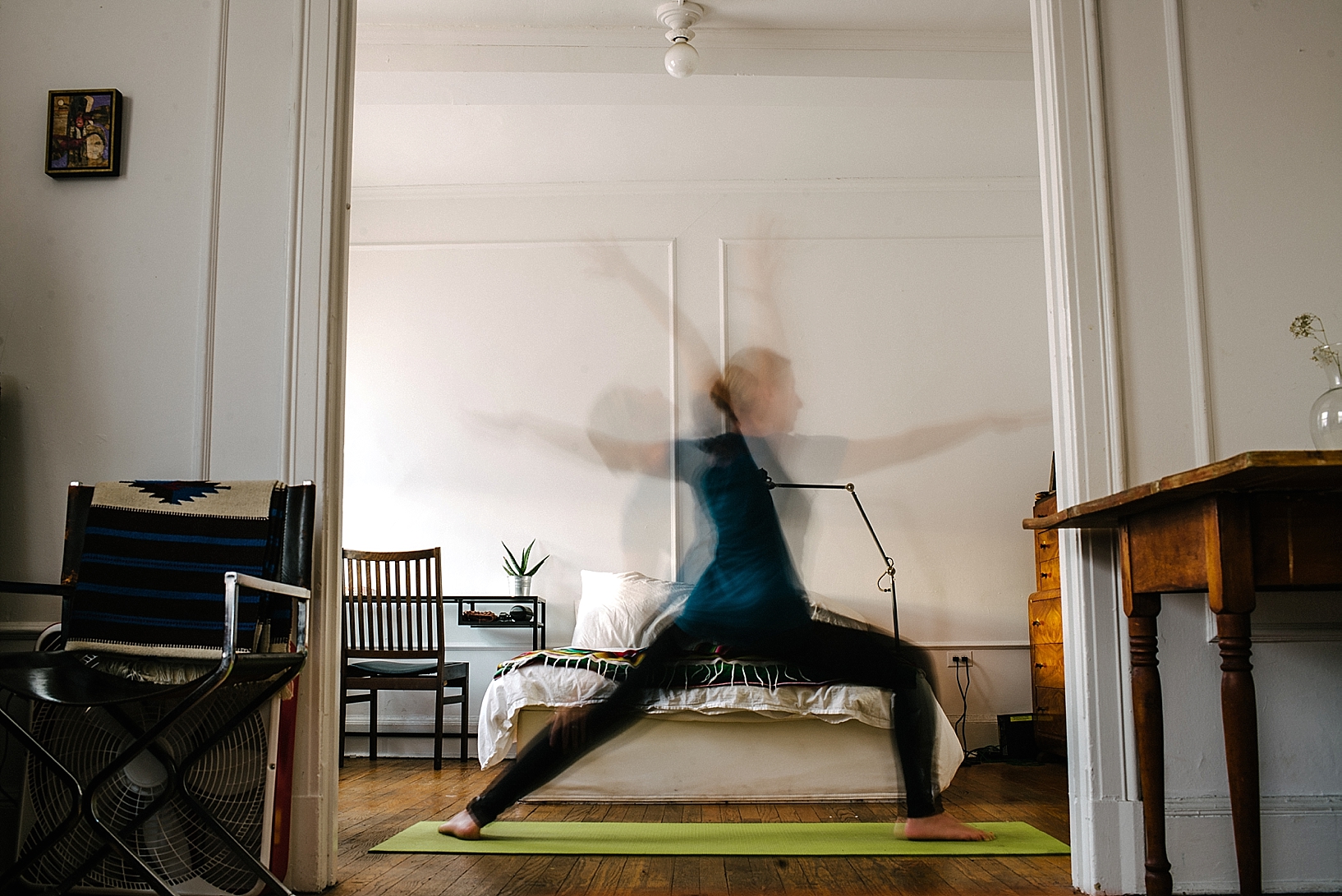 woman doing yoga in studio apartment