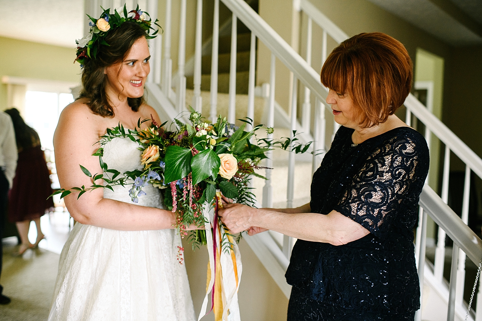 bride showing mother her bouquet
