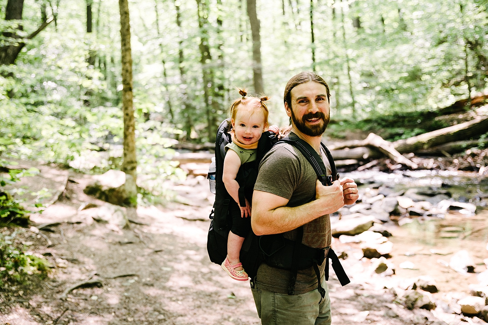 father hiking with toddler in hiking backpack