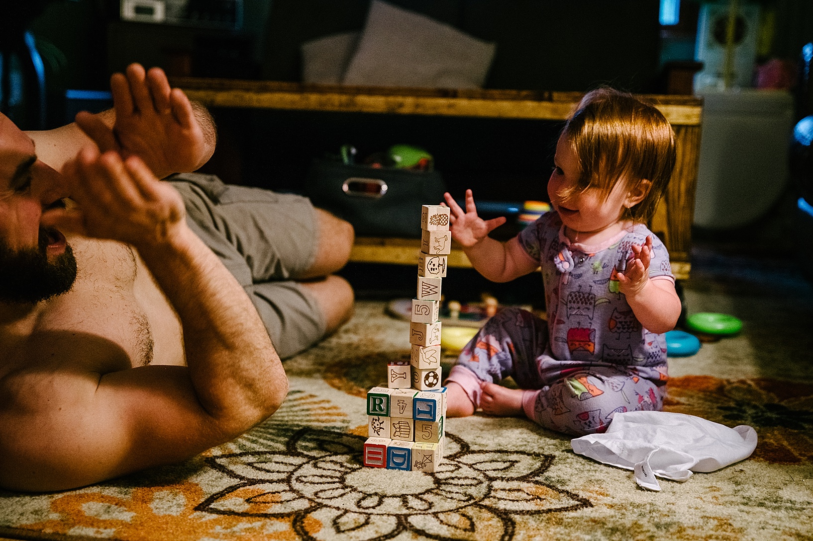toddler building block tower and dad clapping