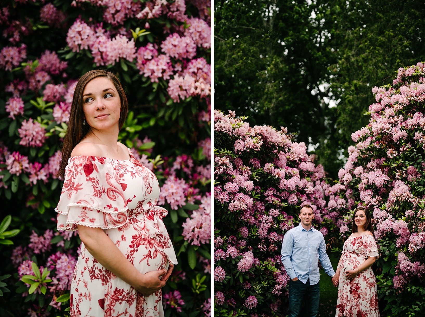 Pregnant brunette woman in a white and red floral dress holds her belly in front of a giant bush of pink flowers