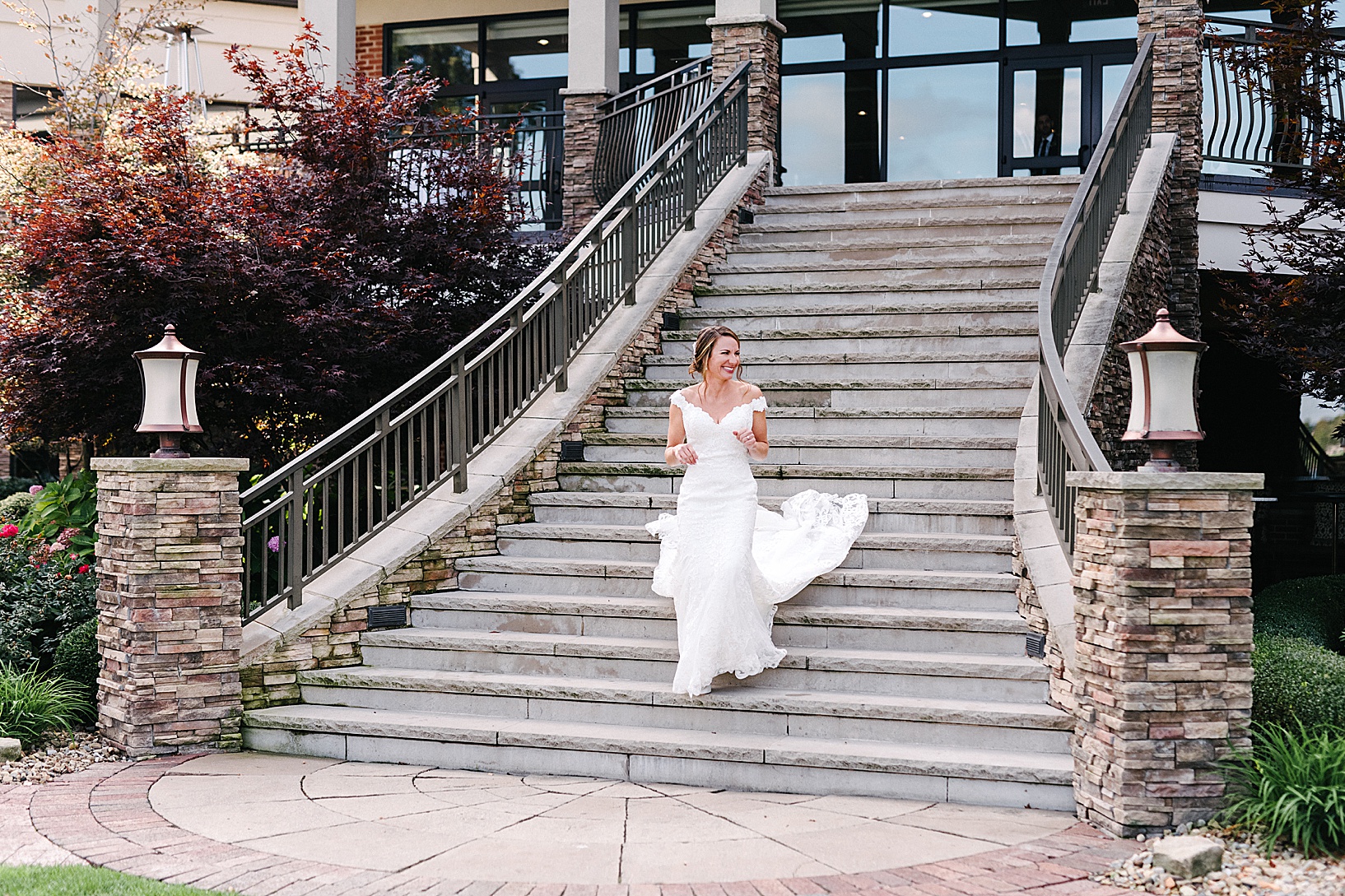 Bride walks down the big steps of the Lake Club for the first look with her groom