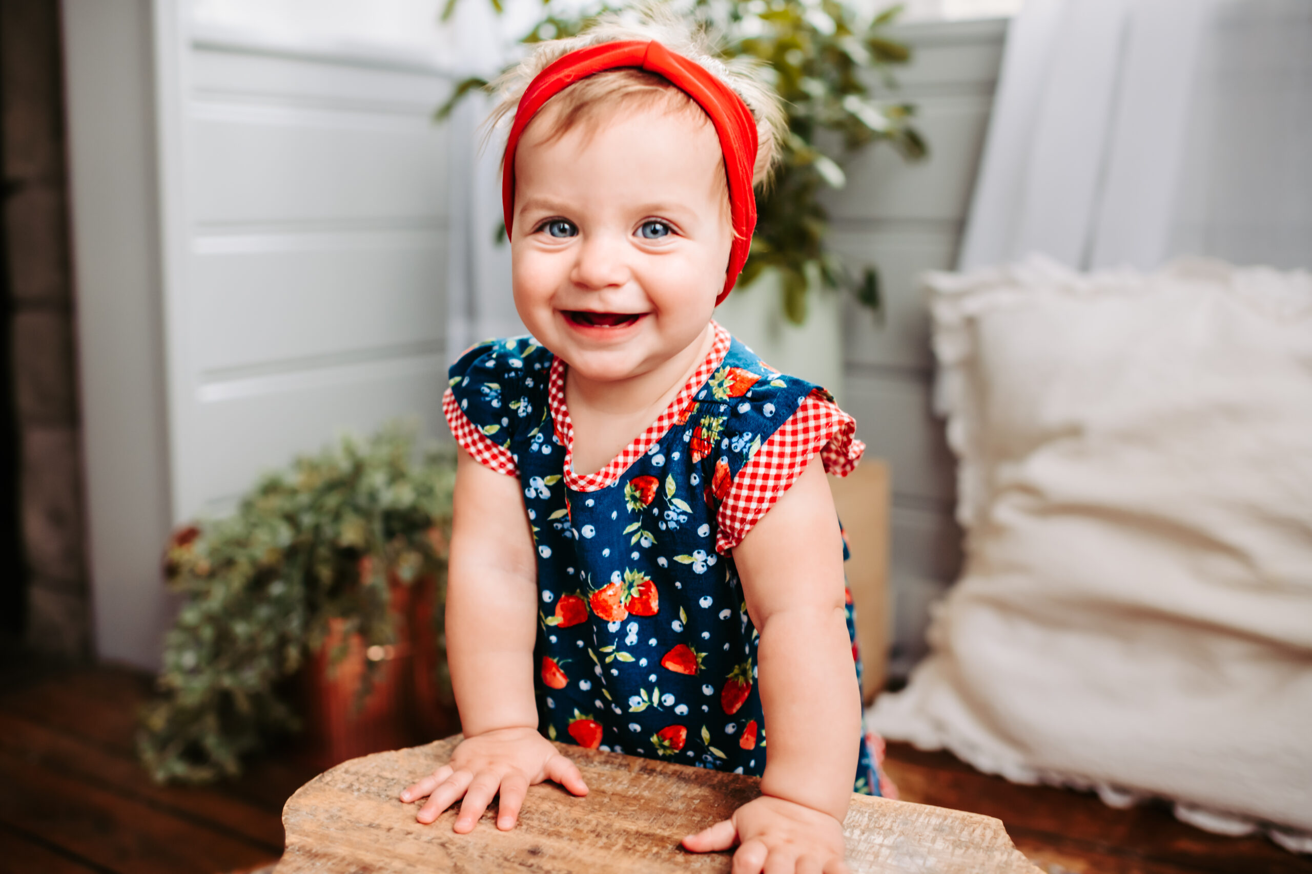 first birthday photoshoot for little girl wearing strawberry print dress